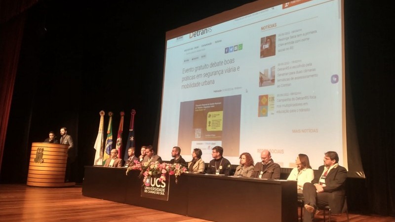 Imagem do palco do evento, onde estão à mesa de abertura as autoridades presentes
